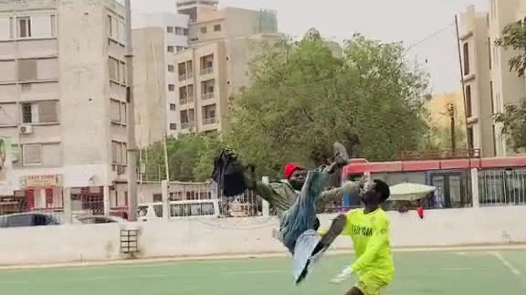 Keeper catches Man falling trying to play the football